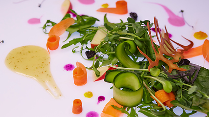 Image showing Mix fresh leaves of arugula, lettuce, spinach, beets for salad on a white background. Selective focus