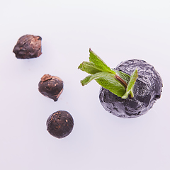Image showing Trendy food. Black ice cream with mint leaves. Copy space.