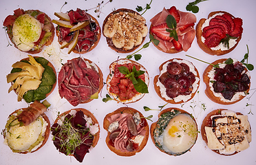 Image showing Crostini with different toppings on white background. Delicious appetizers.