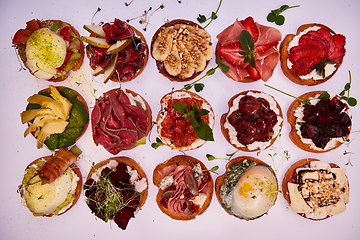 Image showing Crostini with different toppings on white background. Delicious appetizers.