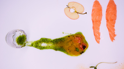 Image showing Puree from apples and greens with salmon cubes. Conceptual aperitif.