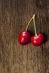 Image showing two connected red cherries