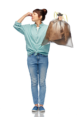Image showing asian woman holding smelly trash in plastic bag
