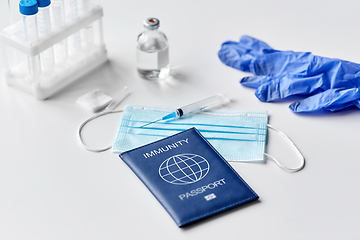 Image showing immunity passport, mask, syringe, vaccine on table