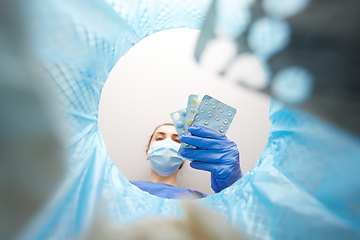 Image showing doctor throwing medicine pills into trash can