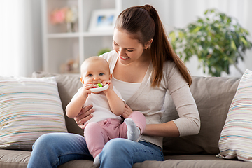 Image showing mother and little baby with teething toy at home