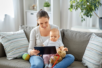 Image showing happy mother and baby girl with tablet pc at home