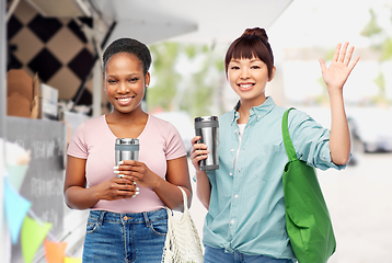 Image showing women with tumblers and bags over food truck