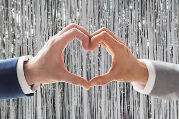 Image showing close up of male gay couple hands showing heart