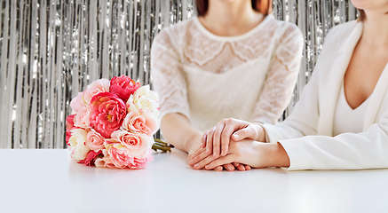 Image showing close up of happy lesbian couple with flowers