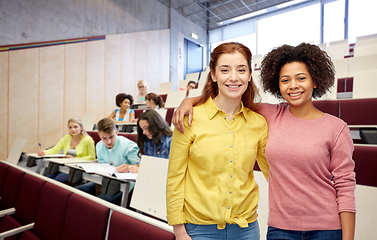 Image showing happy smiling student women hugging at university