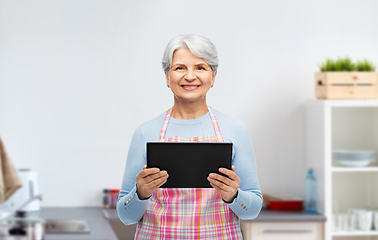 Image showing smiling senior woman with tablet pc at kitchen