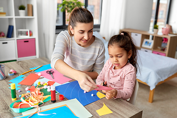 Image showing daughter with mother making applique at home