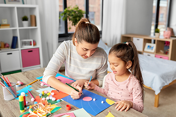 Image showing daughter with mother making applique at home