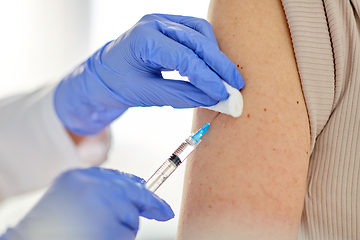 Image showing close up of hand with syringe vaccinating patient