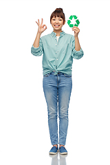 Image showing smiling asian woman holding green recycling sign