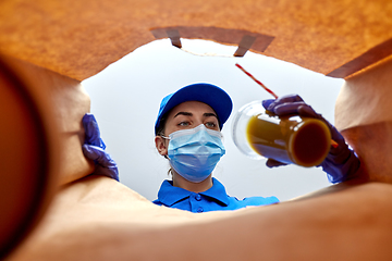 Image showing delivery girl in gloves and mask with food in bag