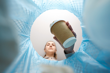 Image showing woman throwing coffee cup into trash can