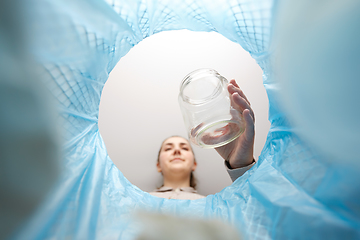 Image showing woman throwing glass jar into trash can