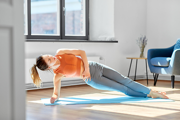 Image showing young woman doing yoga at studio