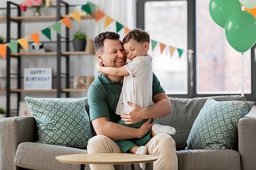 Image showing happy father and little son at home birthday party