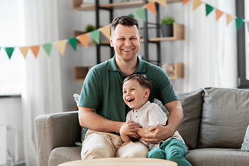 Image showing happy father and little son at home birthday party