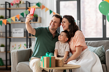 Image showing happy family taking selfie on birthday at home