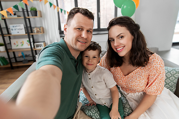 Image showing happy family taking selfie on birthday at home