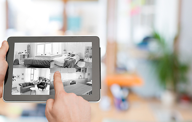 Image showing hands with video control on tablet pc at home