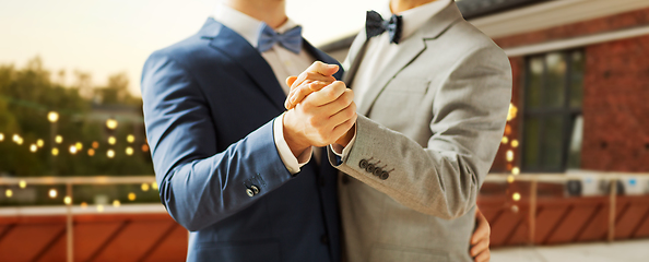 Image showing close up of happy male gay couple dancing at party