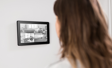 Image showing woman having video control from tablet pc at home