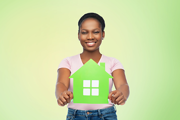 Image showing smiling african american woman holding green house