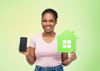 Image showing african woman with smartphone and green house