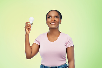 Image showing african american woman holding lighting bulb