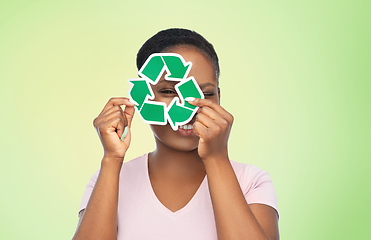 Image showing smiling asian woman holding green recycling sign