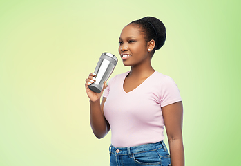 Image showing woman with thermo cup or tumbler for hot drinks