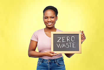 Image showing happy woman holds chalkboard with zero waste words