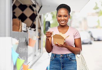 Image showing happy woman with reusable string bag eating wok