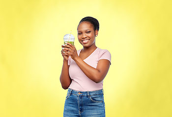 Image showing happy african american woman drinking green juice