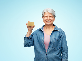 Image showing portrait of smiling senior woman with credit card