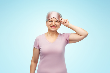 Image showing senior woman in pajamas and eye sleeping mask