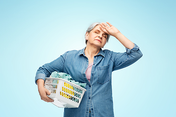 Image showing tired senior woman with laundry basket