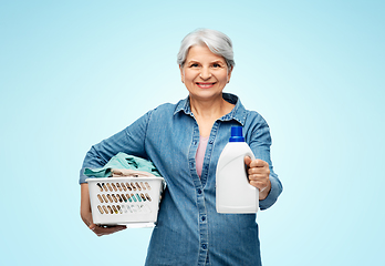 Image showing smiling senior woman with laundry basket