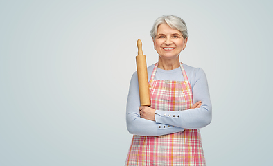 Image showing smiling senior woman in apron with rolling pin