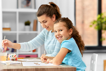 Image showing happy mother with little daughter drawing at home