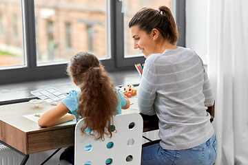 Image showing happy mother with little daughter drawing at home