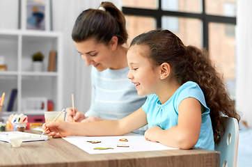 Image showing happy mother with little daughter drawing at home