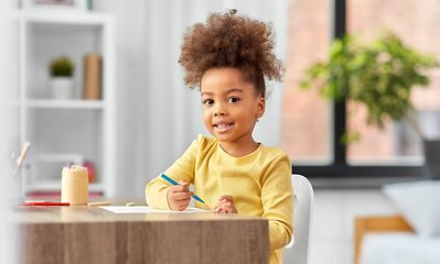 Image showing little girl with felt pen drawing picture at home