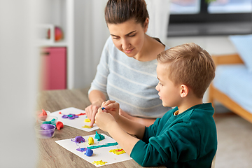 Image showing mother and son playing with modeling clay at home