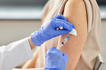 Image showing close up of hand with syringe vaccinating patient